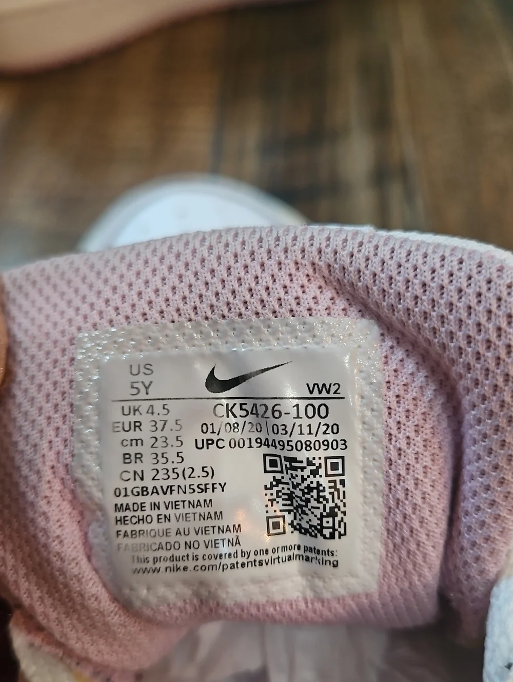 Nike White Low-Top Sneakers with Marbled Swoosh and Pink Details